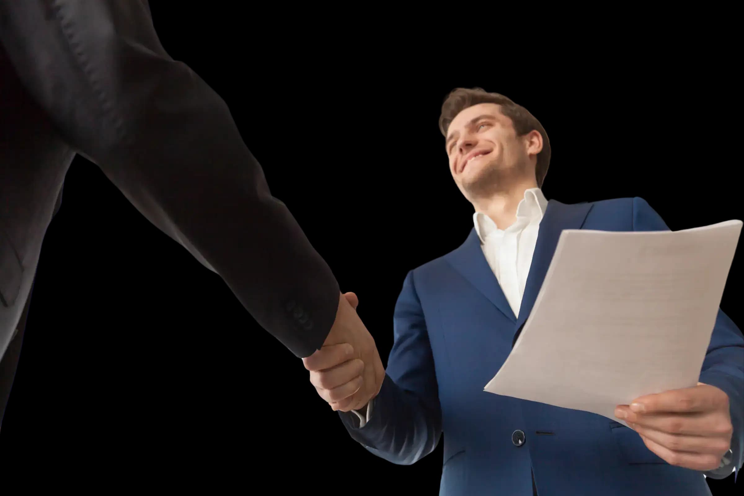 Two business professionals in formal attire shaking hands, one holding paperwork, symbolizing agreement, trust, and the importance of a well-crafted operating agreement for your business.