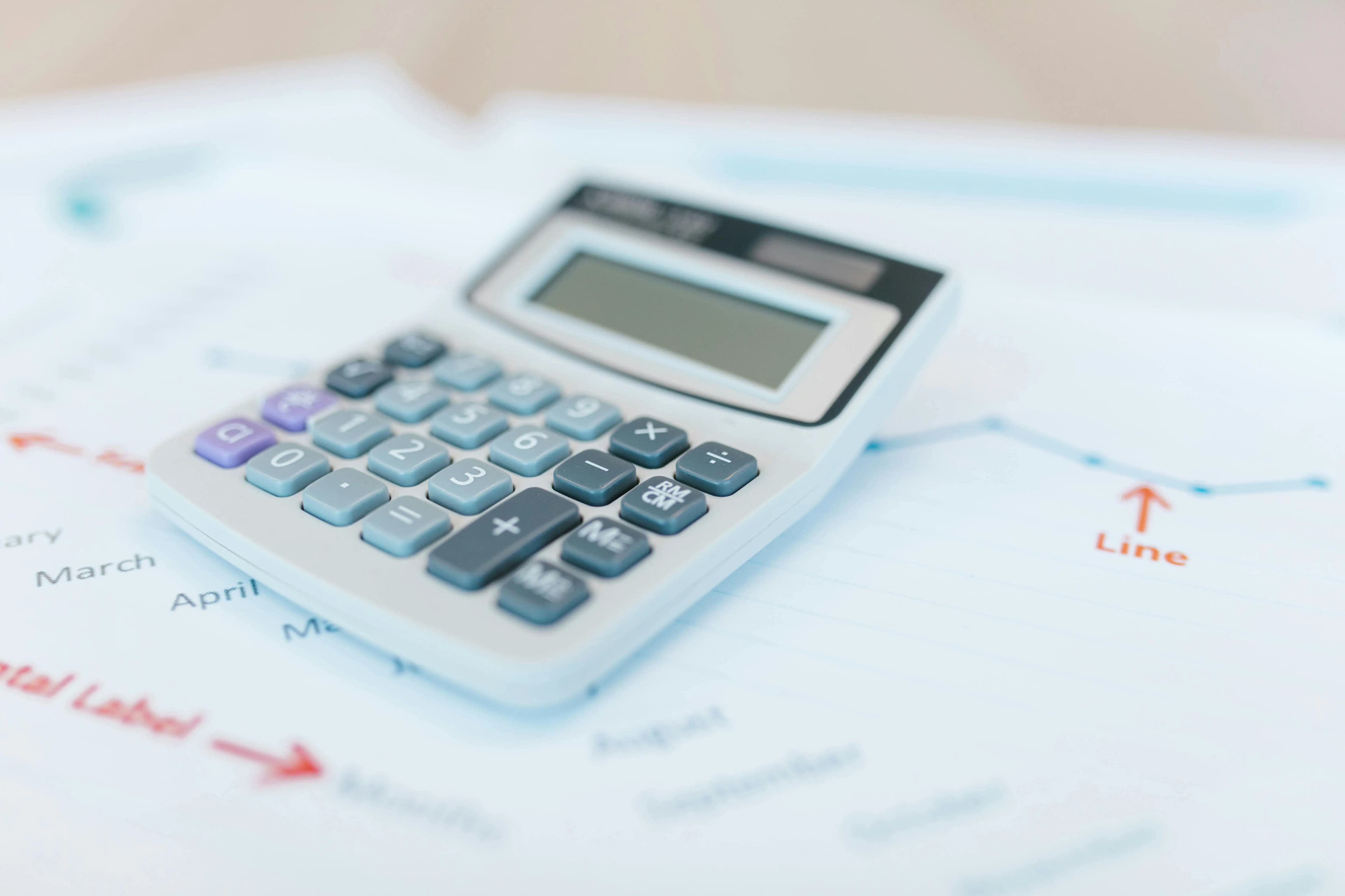 Financial tools including a calculator and trend graphs illustrating fiscal year review and annual reporting.