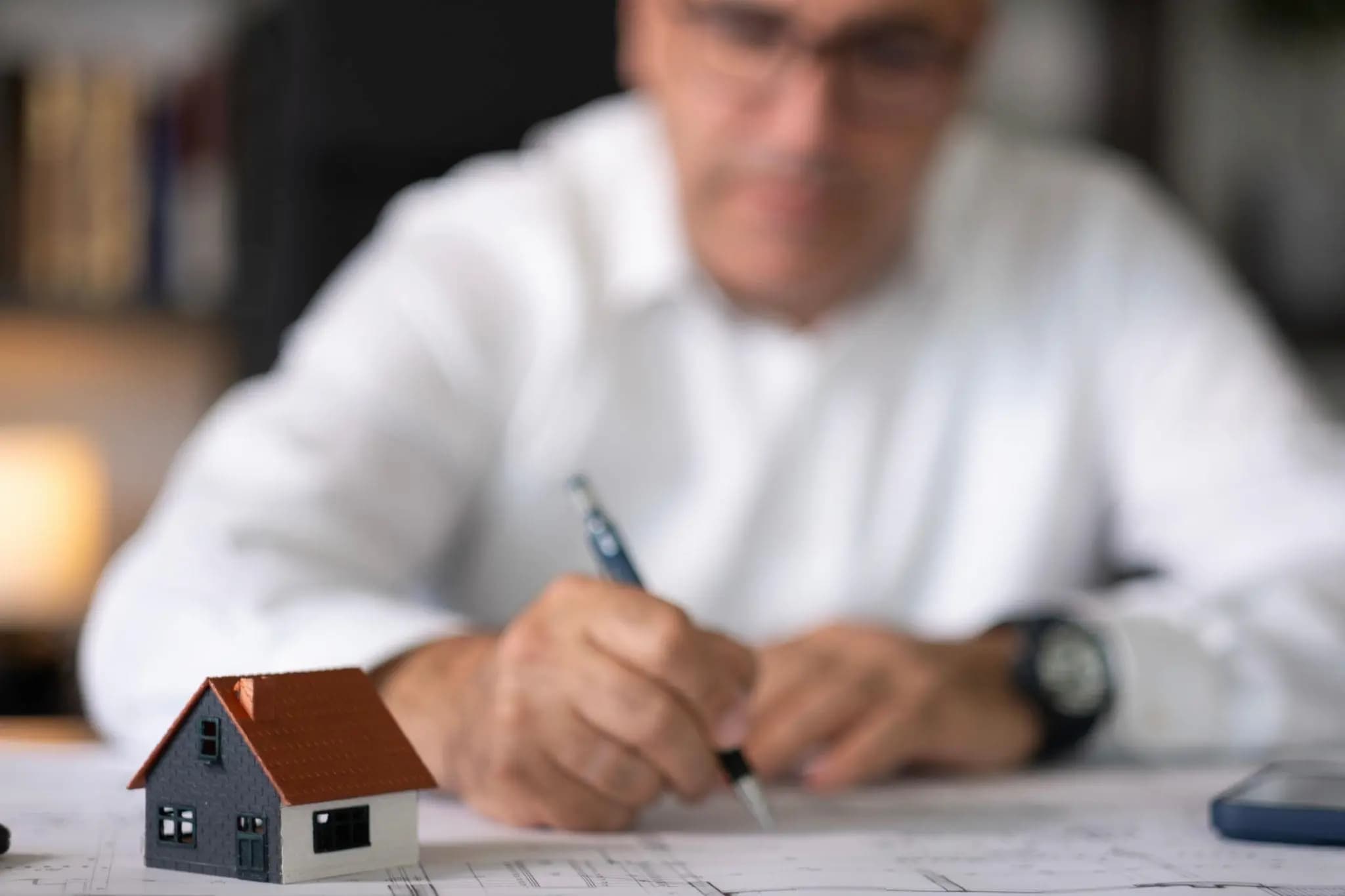 Professional investor in a bright, modern office using a laptop for a Florida foreign entity registration.