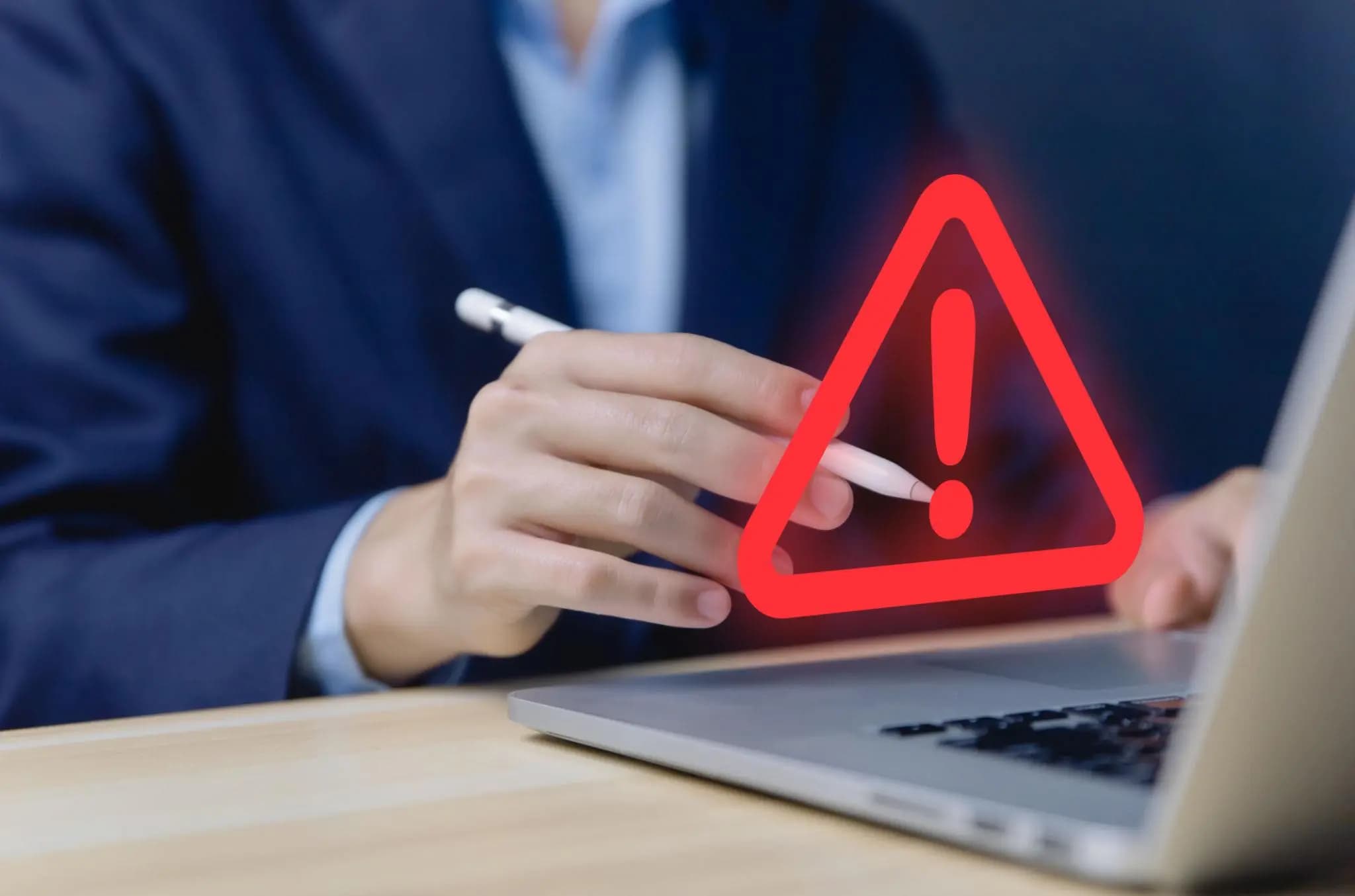 Professional at a laptop viewing a glowing red warning triangle, acting to reinstate Florida corporation.